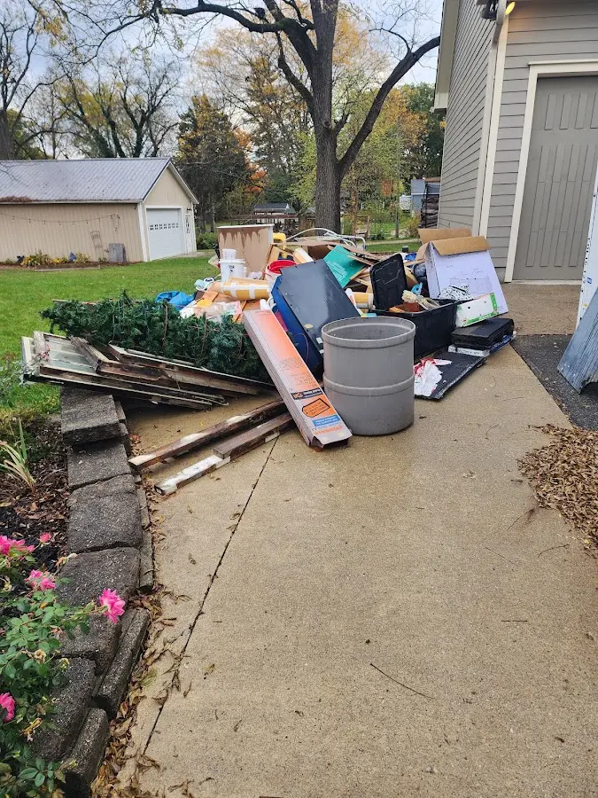 Dumpster being loaded with debris for 12 Yard Dumpster Rental in Zephyrhills